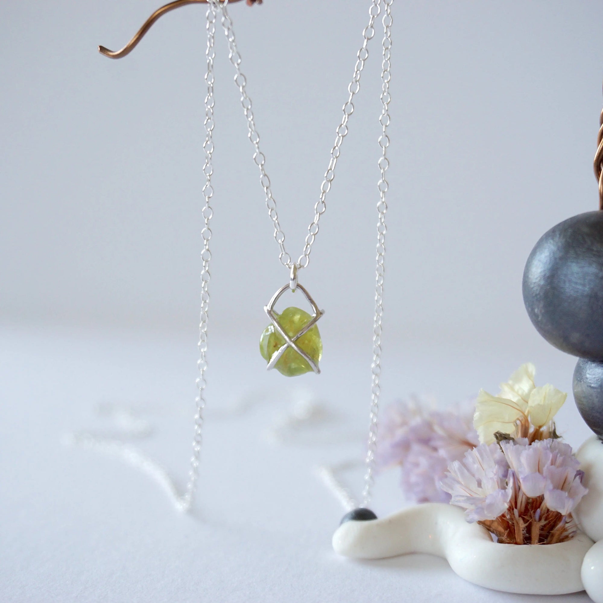 Back view of minimalist raw peridot pendant — 925 sterling silver four-prong setting and bail detail, handcrafted dainty crystal necklace for women, August birthstone jewelry