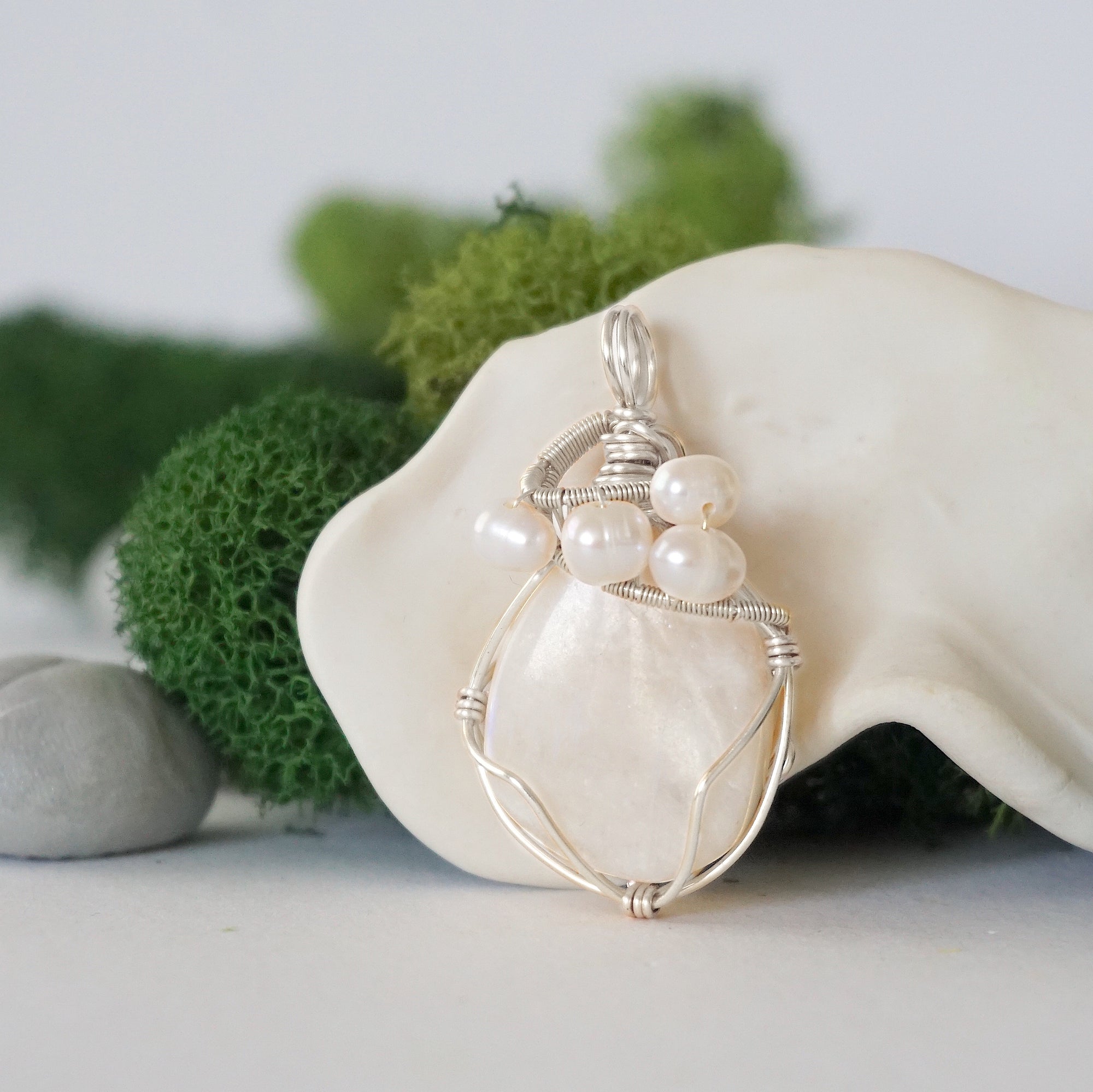 Detailed front view of silver wire wrapped moonstone and freshwater pearl pendant, unique artisan necklace