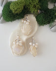 Three silver wire wrapped moonstone and freshwater pearl pendants showing natural stone variation, artisan jewelry for women