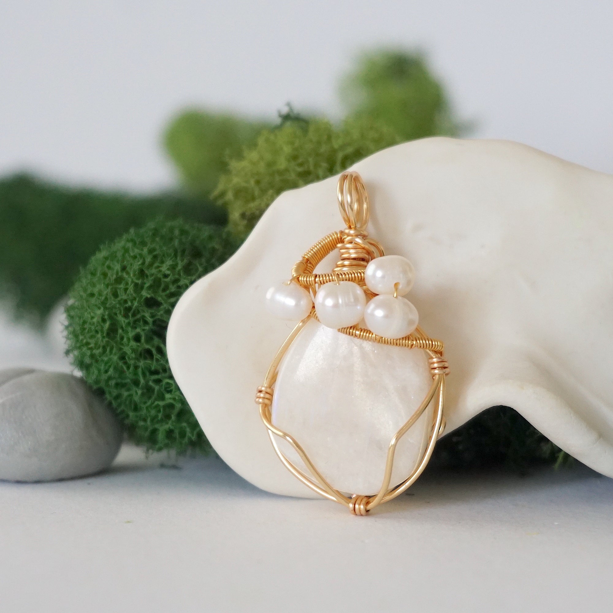 Detailed front angle of moonstone and freshwater pearl pendant, gold wire wrapped, handcrafted gemstone jewelry