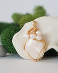 Detailed front angle of moonstone and freshwater pearl pendant, gold wire wrapped, handcrafted gemstone jewelry