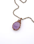 Natural amethyst wire wrapped pendant necklace on antique bronze chain, flat lay product photo