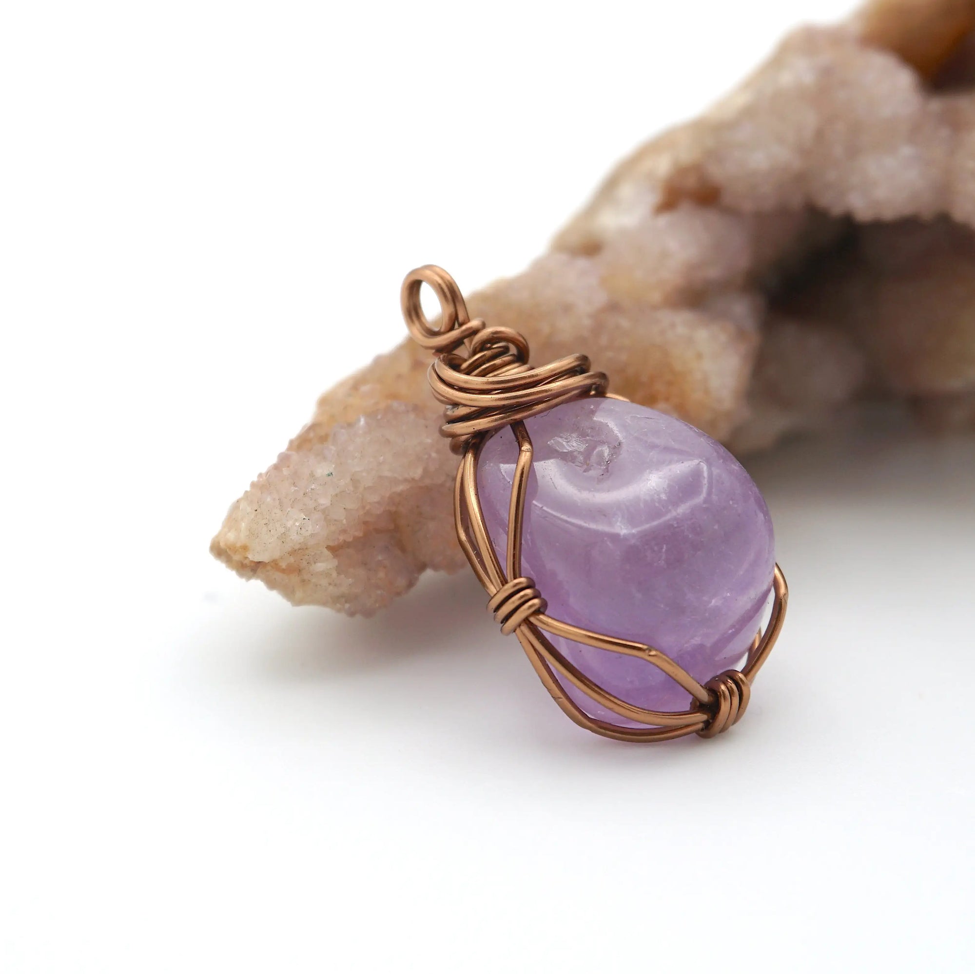 Side angle detail of natural amethyst wire wrapped pendant in antique bronze copper, handmade necklace