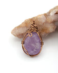 Back view detail of natural amethyst pendant necklace with simple antique bronze copper wire wrap
