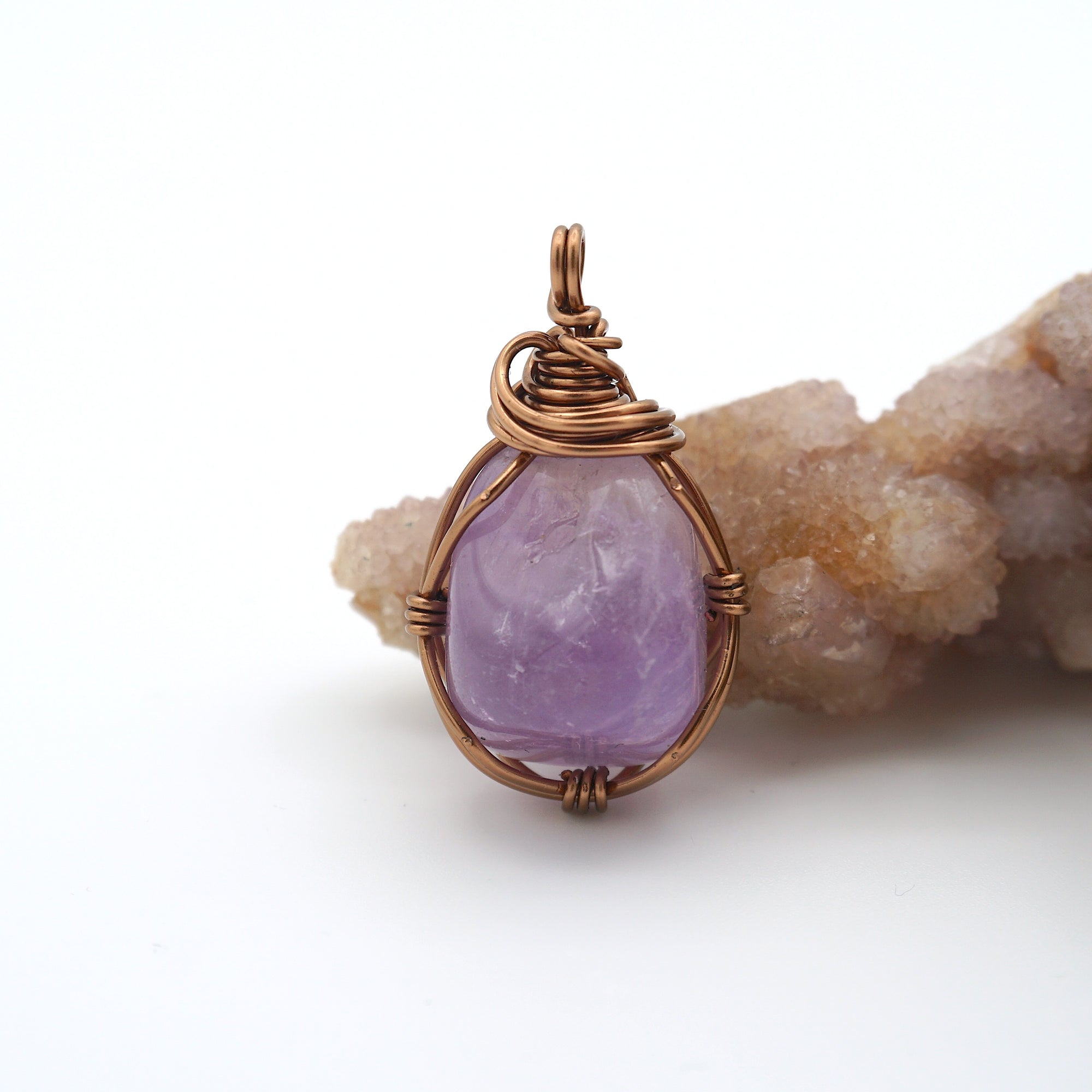 Front view of natural amethyst pendant necklace, simple wire wrap in antique bronze copper