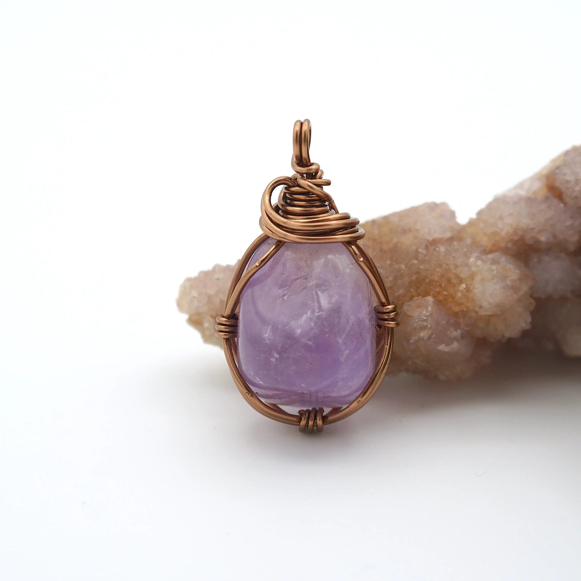 Front view of natural amethyst pendant necklace, simple wire wrap in antique bronze copper