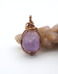 Front view of natural amethyst pendant necklace, simple wire wrap in antique bronze copper