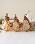 Three natural citrine crystals showing variation in color size and shape - pale yellow to golden amber unique wire wrapped antique bronze pendants one of a kind