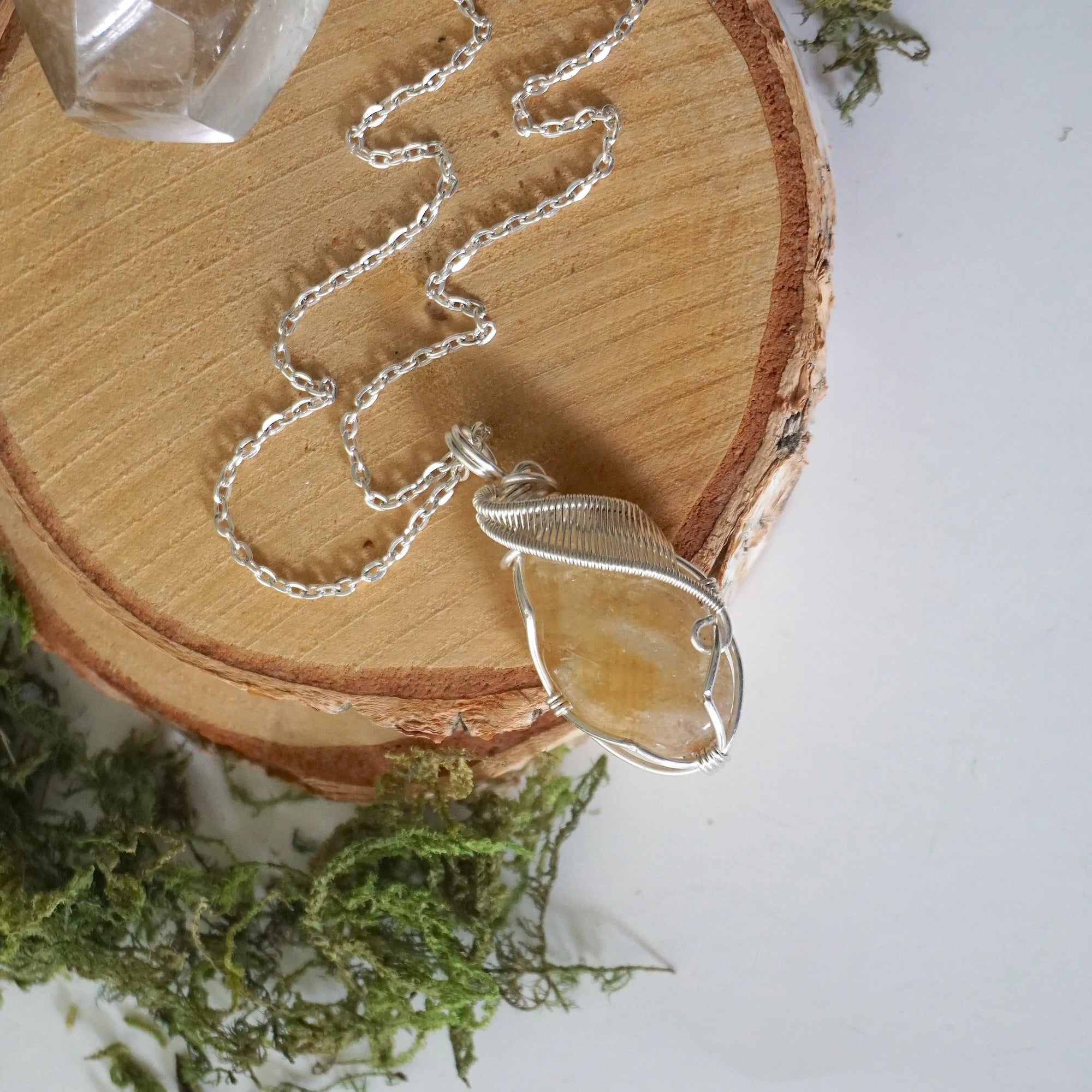 Natural citrine necklace laying flat on silver plated copper chain - handmade wire wrapped crystal pendant full view minimalist jewelry for women November birthstone