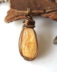 Front view of natural citrine pendant showing crystal texture and wire wrapping - antique bronze copper handmade unisex jewelry for women and men November birthstone detail