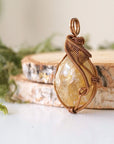 Side angle of natural citrine pendant showing crystal dimension and wire wrap detail - antique bronze copper handmade vintage necklace profile view jewelry