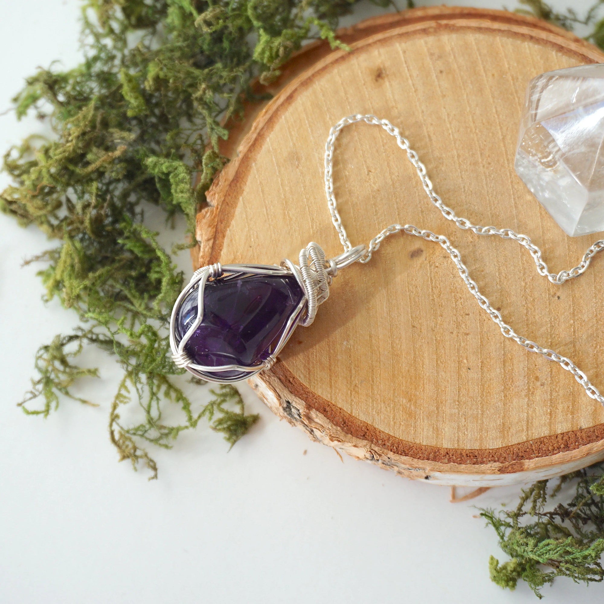 Natural dark amethyst pendant necklace on sterling silver chain, flat lay product photo