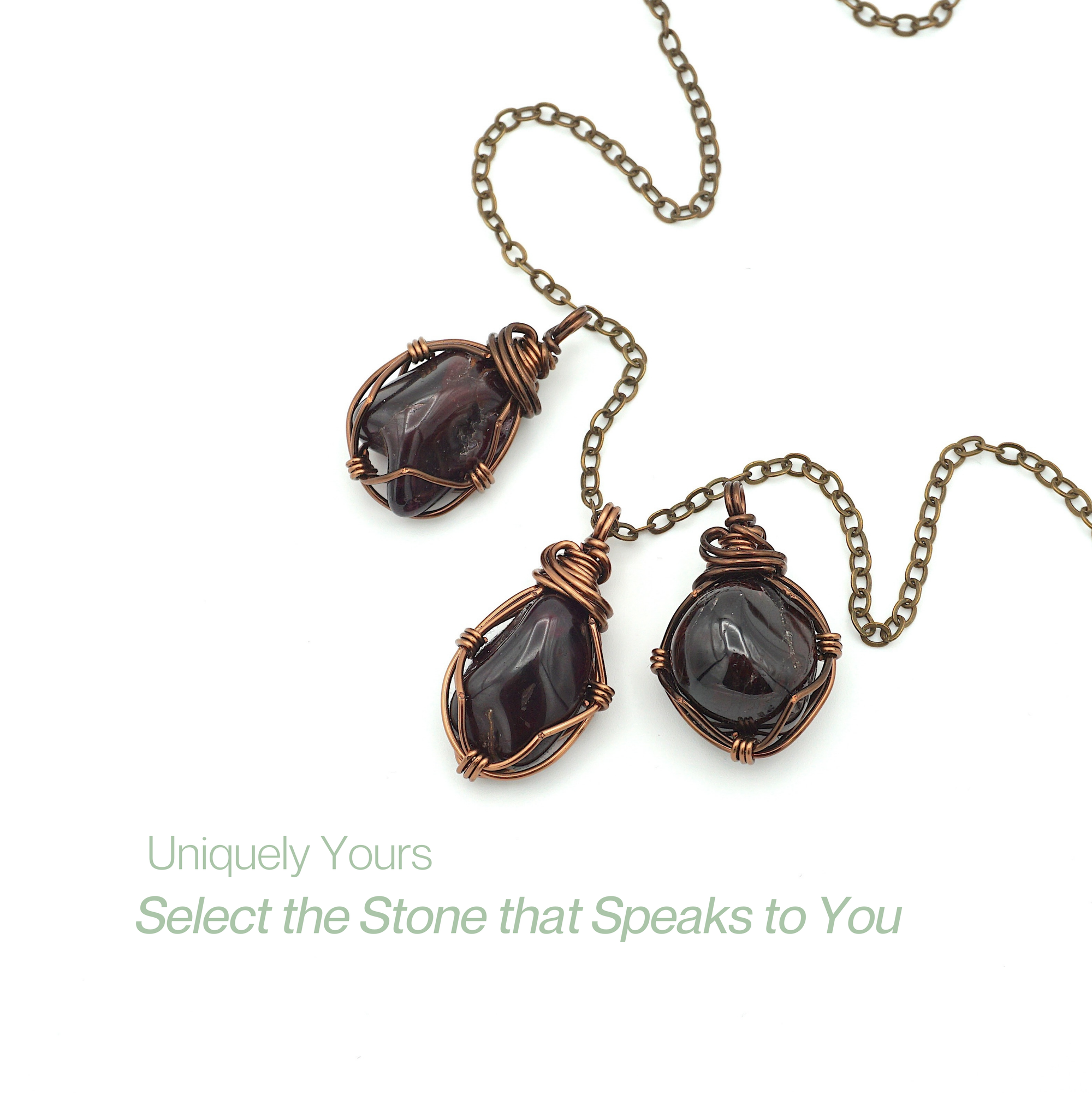 Three different raw garnet pendants on one antique bronze copper chain showing natural stone variation