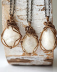Three natural moonstone necklaces showing natural variation in pendant size, shape, and creamy moonstone color (June birthstone).