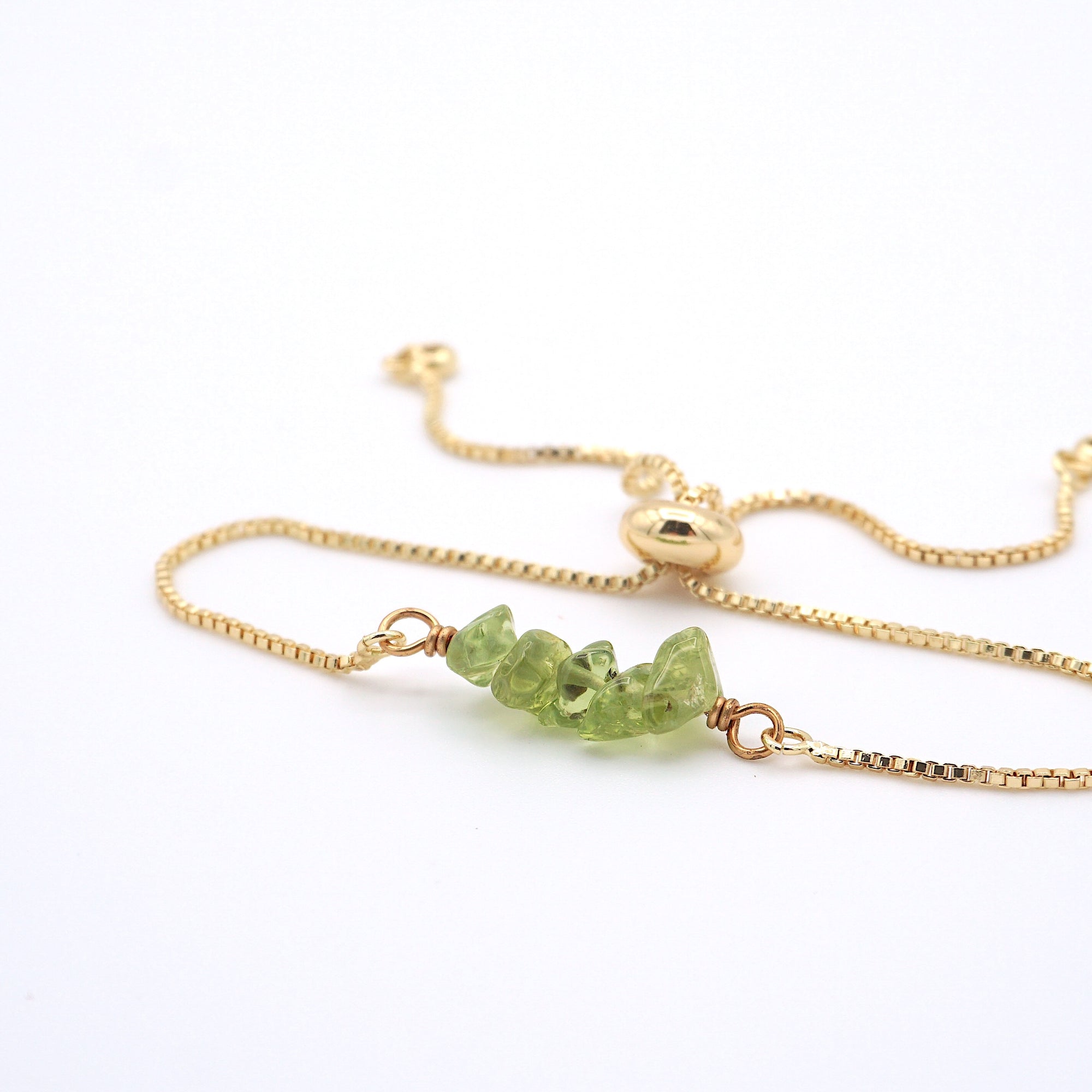 Natural peridot slider bracelet with raw green crystals on gold plated chain, handmade August birthstone jewelry