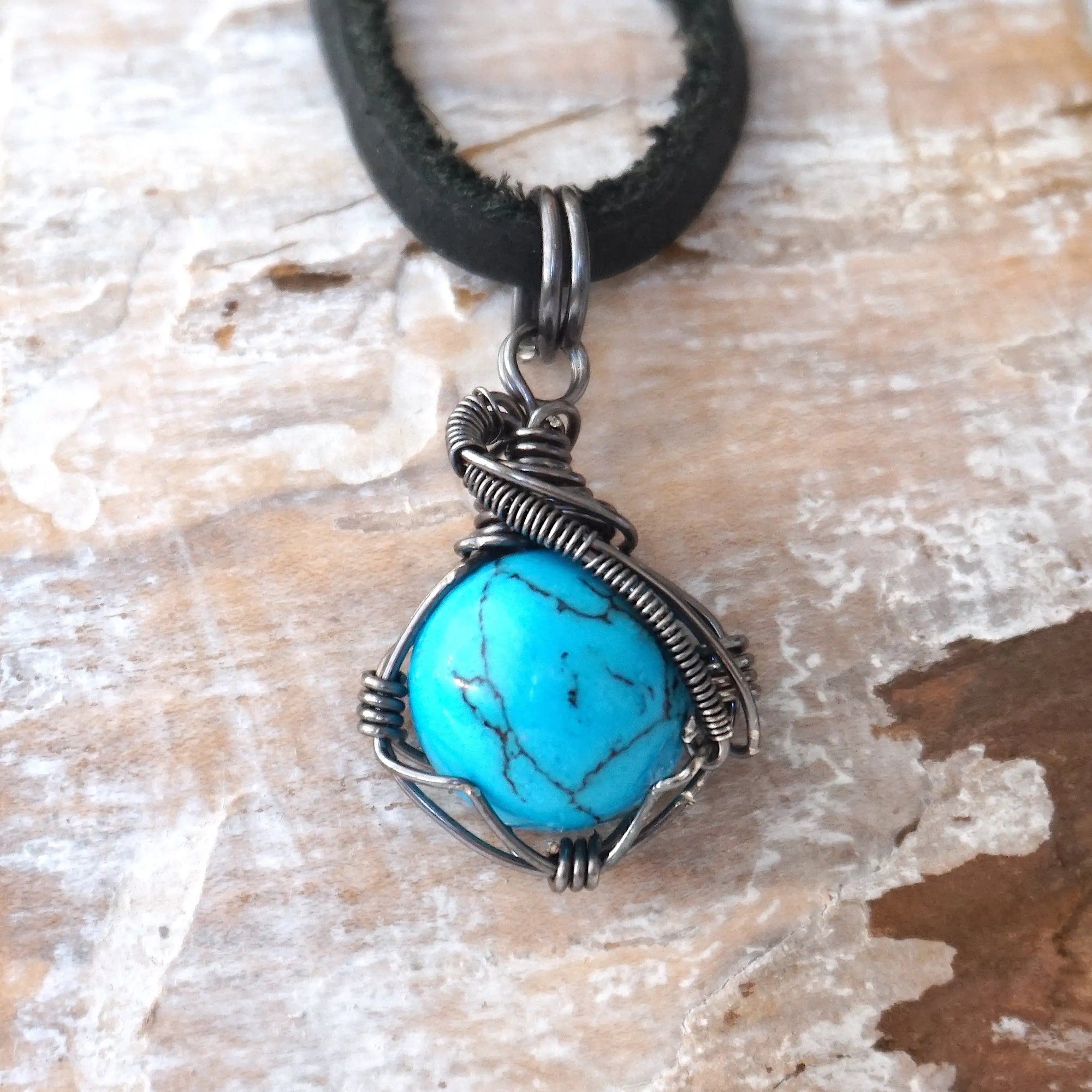 Natural turquoise necklace for men with sterling silver wire wrapping on black leather cord