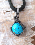Natural turquoise necklace for men with sterling silver wire wrapping on black leather cord