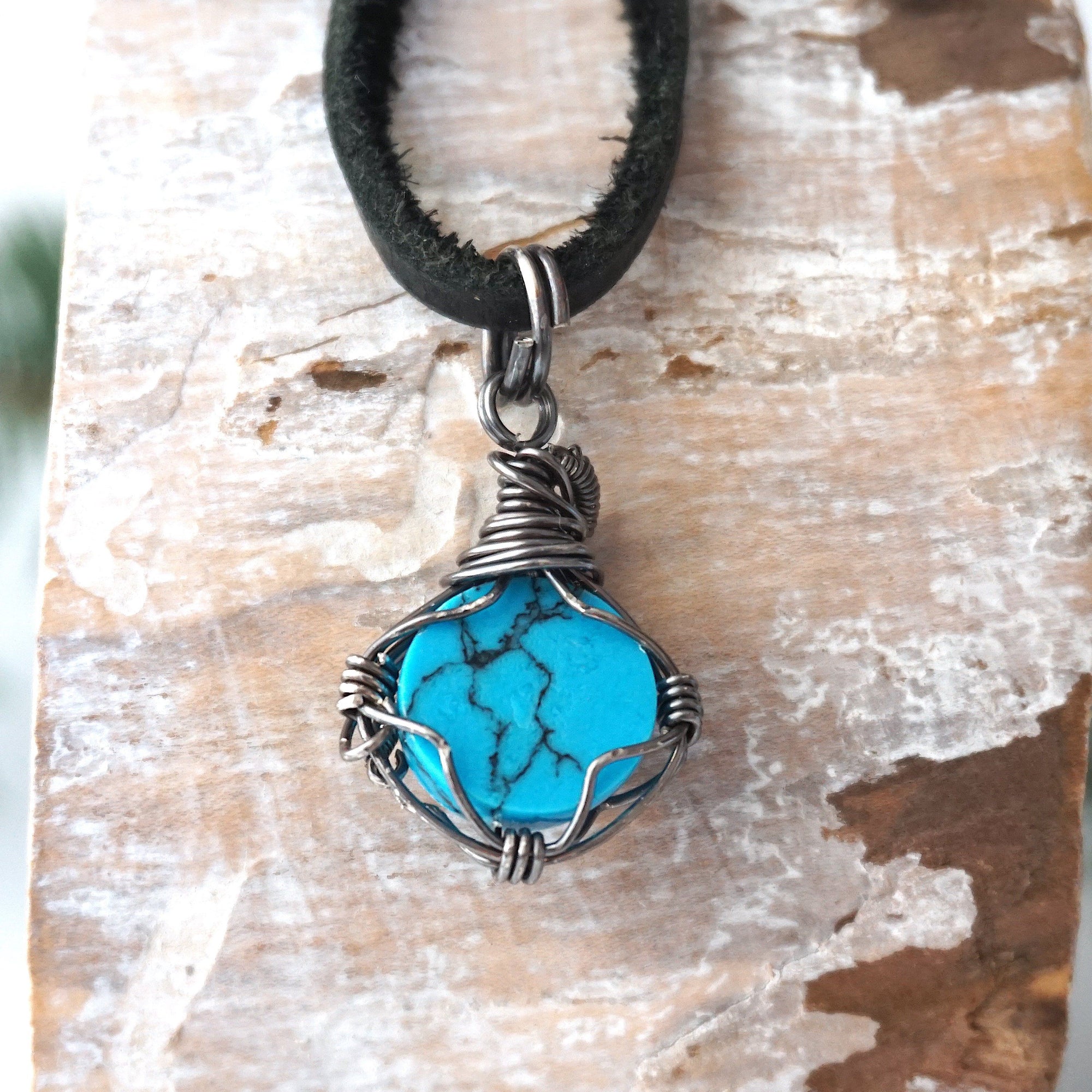 Natural turquoise pendant back view with sterling silver wire wrap detail black cord