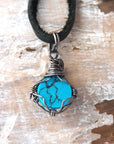 Natural turquoise pendant back view with sterling silver wire wrap detail black cord