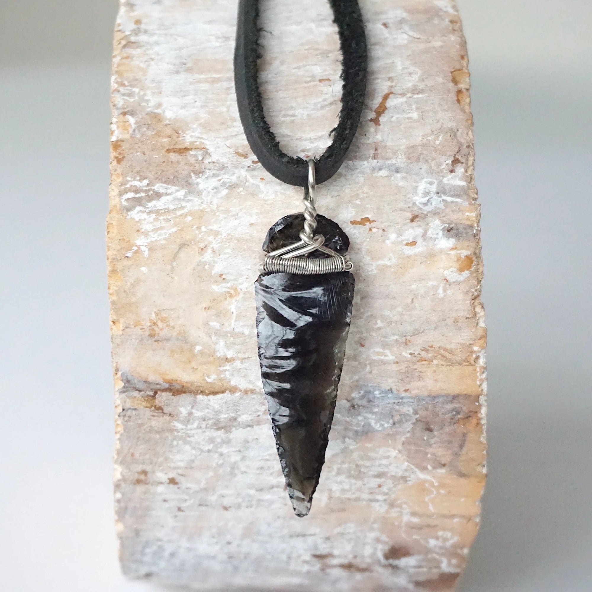 Detailed back view of black obsidian arrowhead pendant, handcrafted men’s necklace by Designs by Nature Gems.