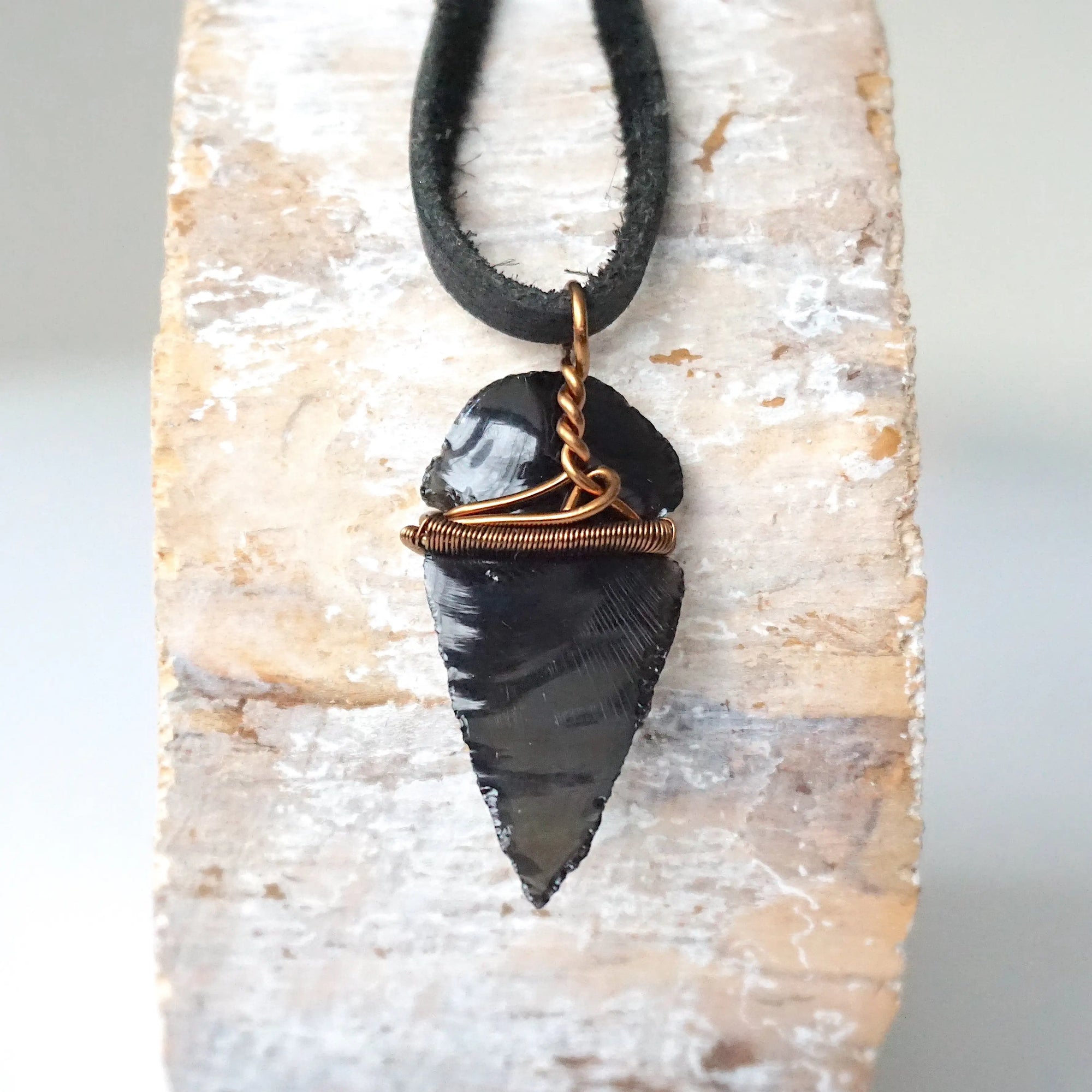 Back view of black obsidian arrowhead pendant with antique bronze copper wire wrap, handcrafted men’s necklace by Designs by Nature Gems.