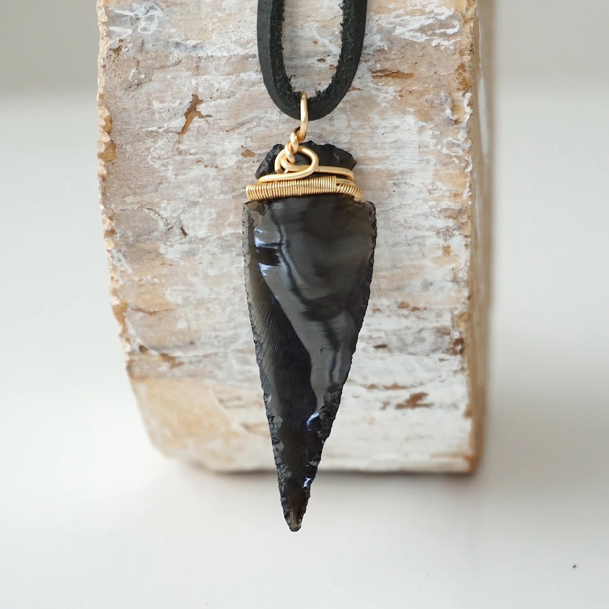 Back view of black obsidian arrowhead pendant with gold plated copper wire wrap, handcrafted men’s necklace by Designs by Nature Gems.