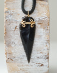 Detailed front view of men’s black obsidian arrowhead necklace on black leather cord, gold plated copper wire wrap, by Designs by Nature Gems.