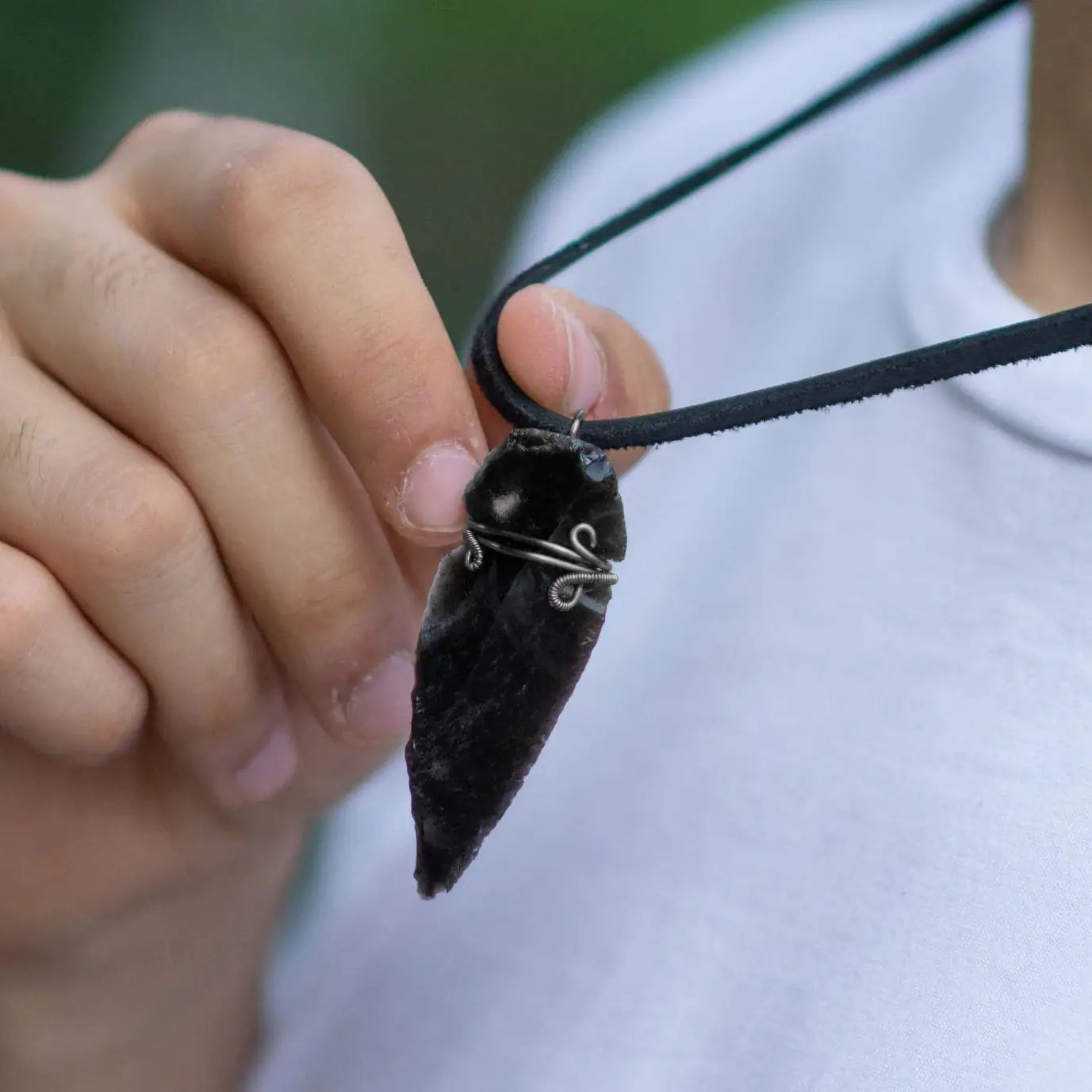 Men’s black obsidian arrowhead necklace on male model, artisan wire wrapped pendant, handcrafted by Designs by Nature Gems.