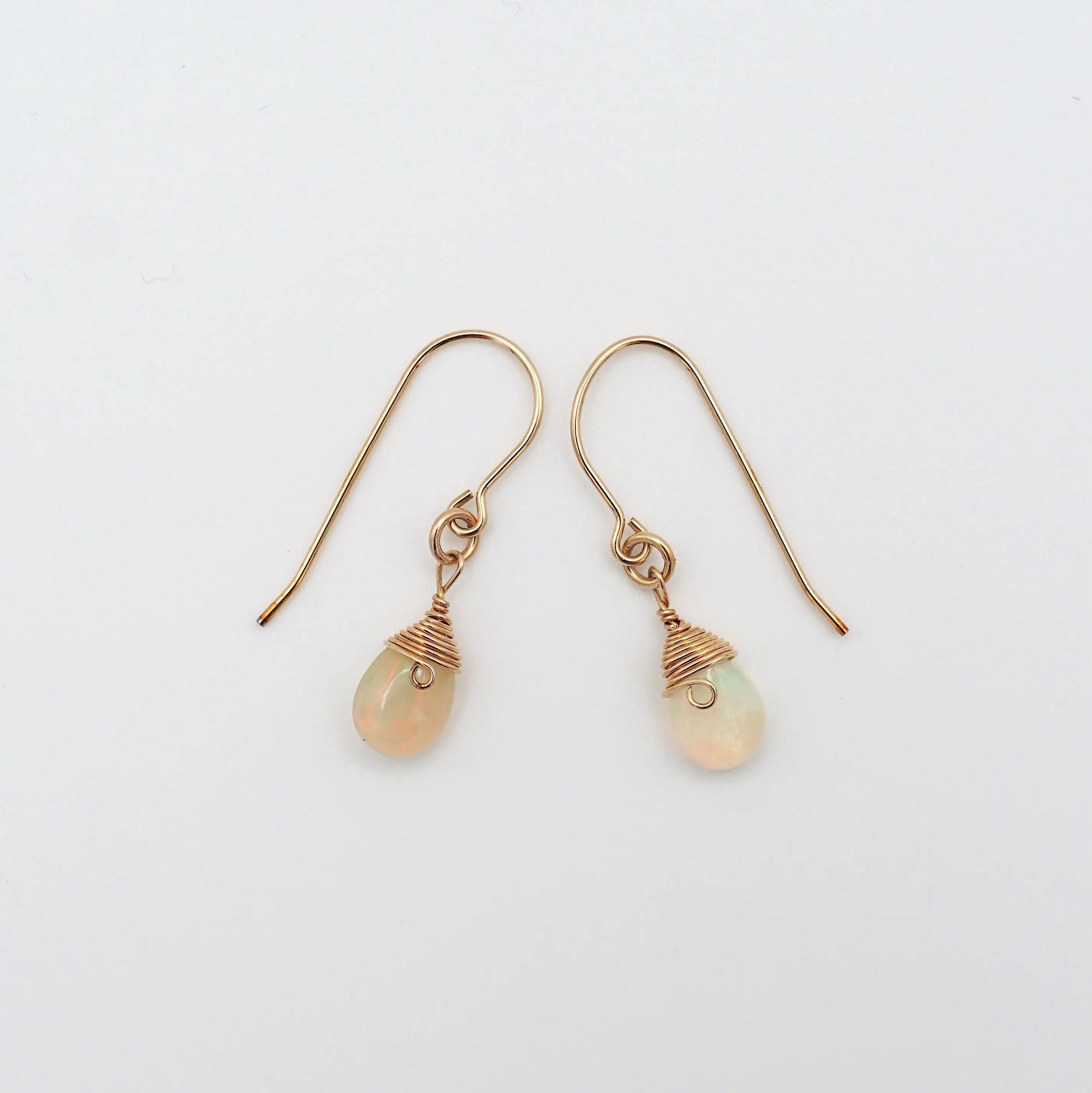Side angle of opal drop earrings, minimalist artisan wire wrapping, 14k gold filled