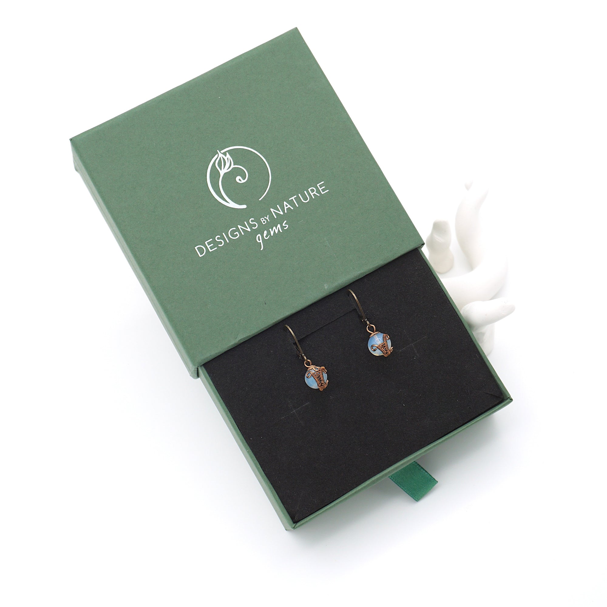 Opal drop earrings presented in a branded gift box, ready for gifting, with antique bronze copper wire wrapping.