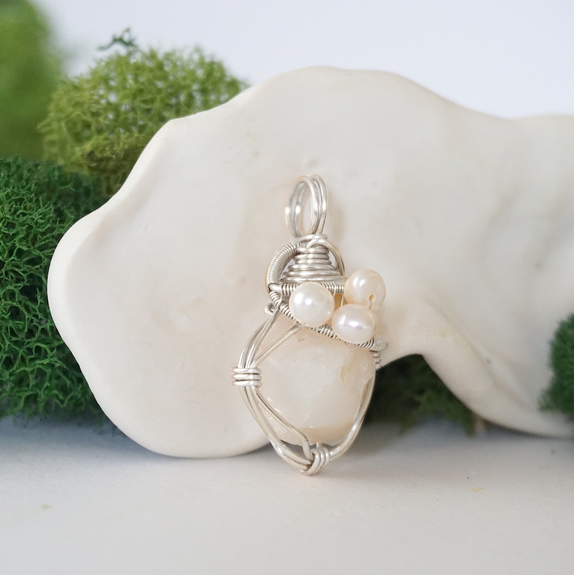 Side angle of handmade opal and freshwater pearl pendant necklace, silver wire wrapped jewelry