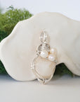 Side angle of handmade opal and freshwater pearl pendant necklace, silver wire wrapped jewelry