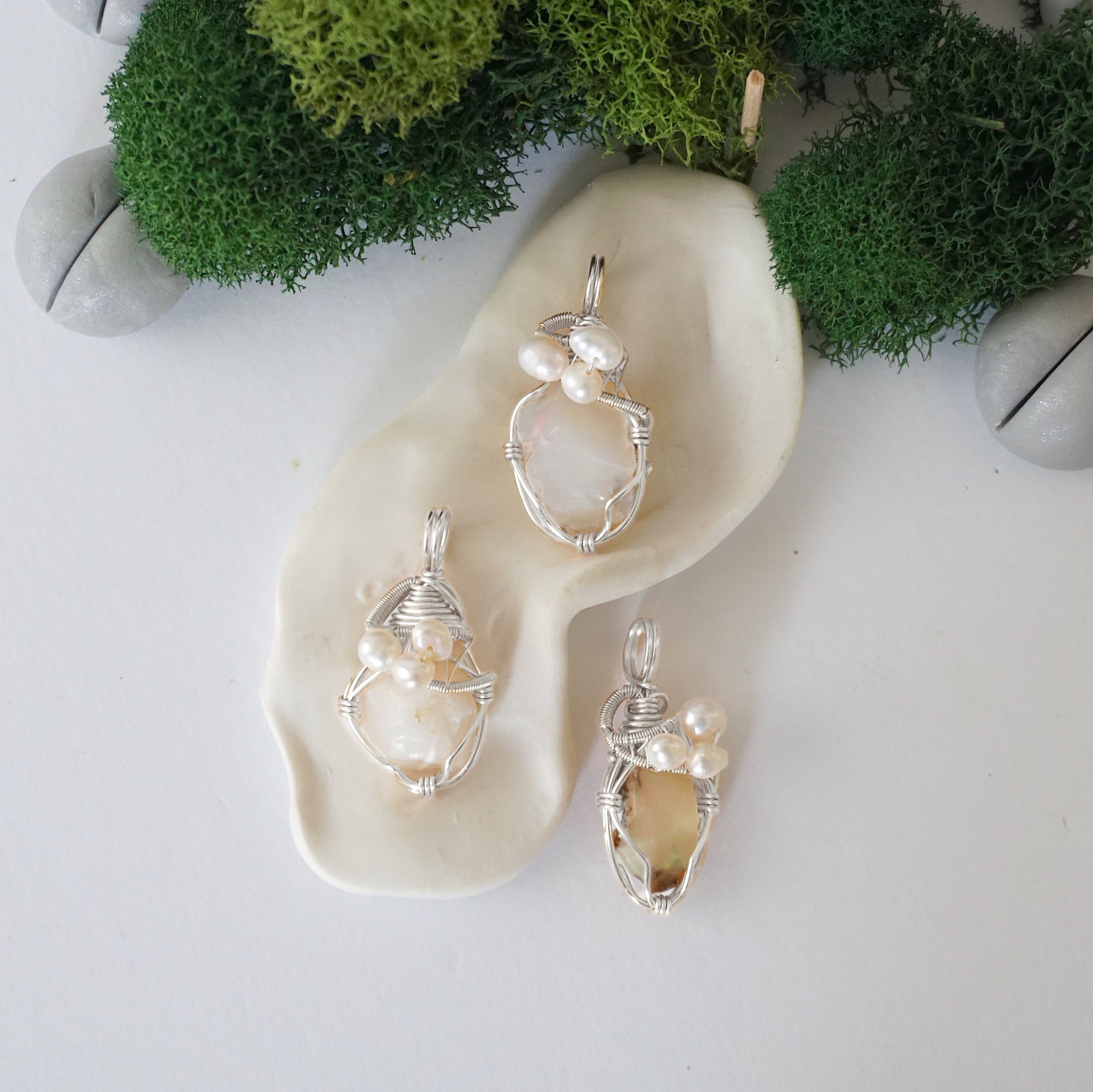 Three silver wire wrapped opal and freshwater pearl pendants showing natural stone variation, artisan jewelry for women