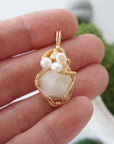 Opal and freshwater pearl necklace pendant in hand for size reference, artisan birthstone jewelry gift for her