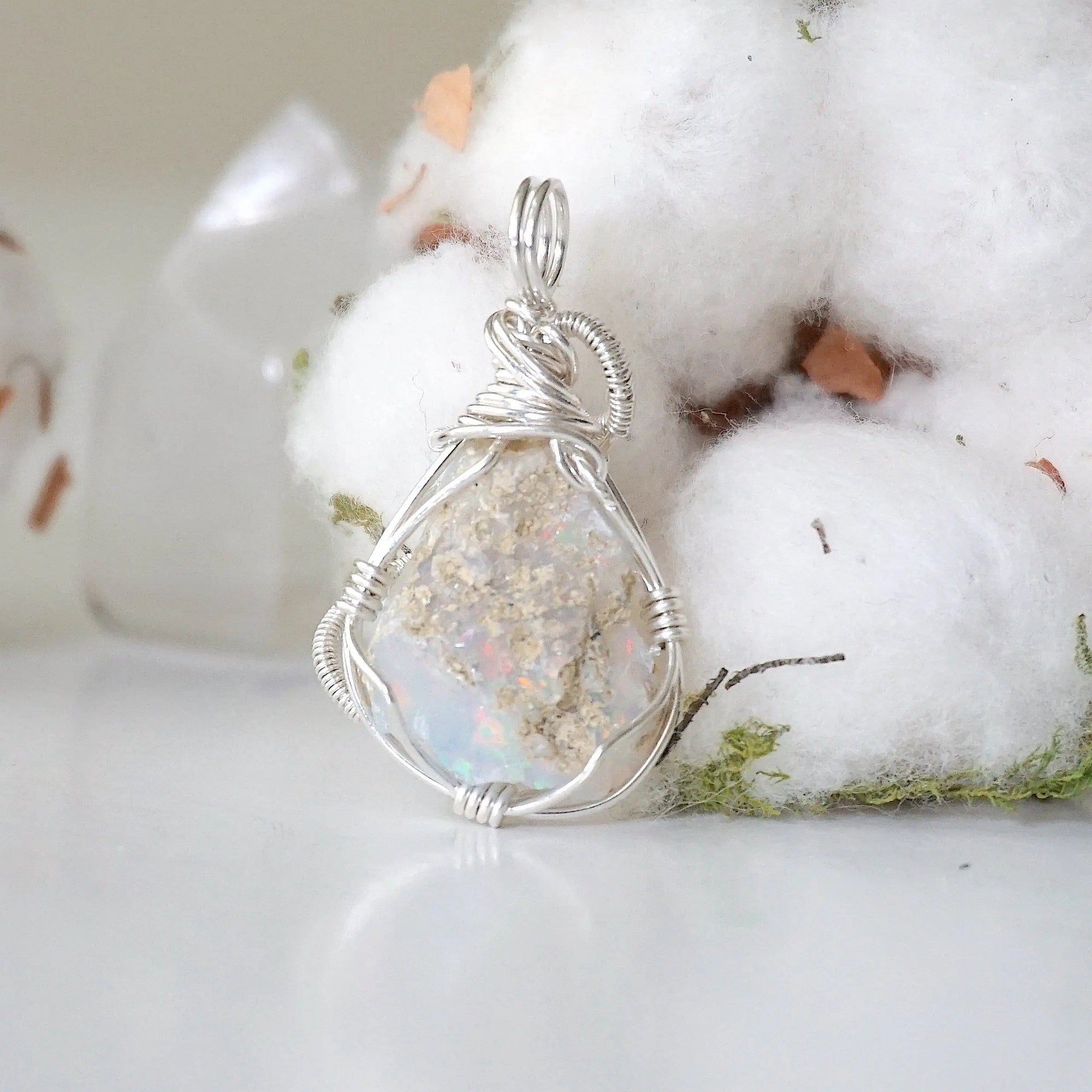 Back side angle view of sterling silver opal pendant, handcrafted jewelry by Designs by Nature Gems.