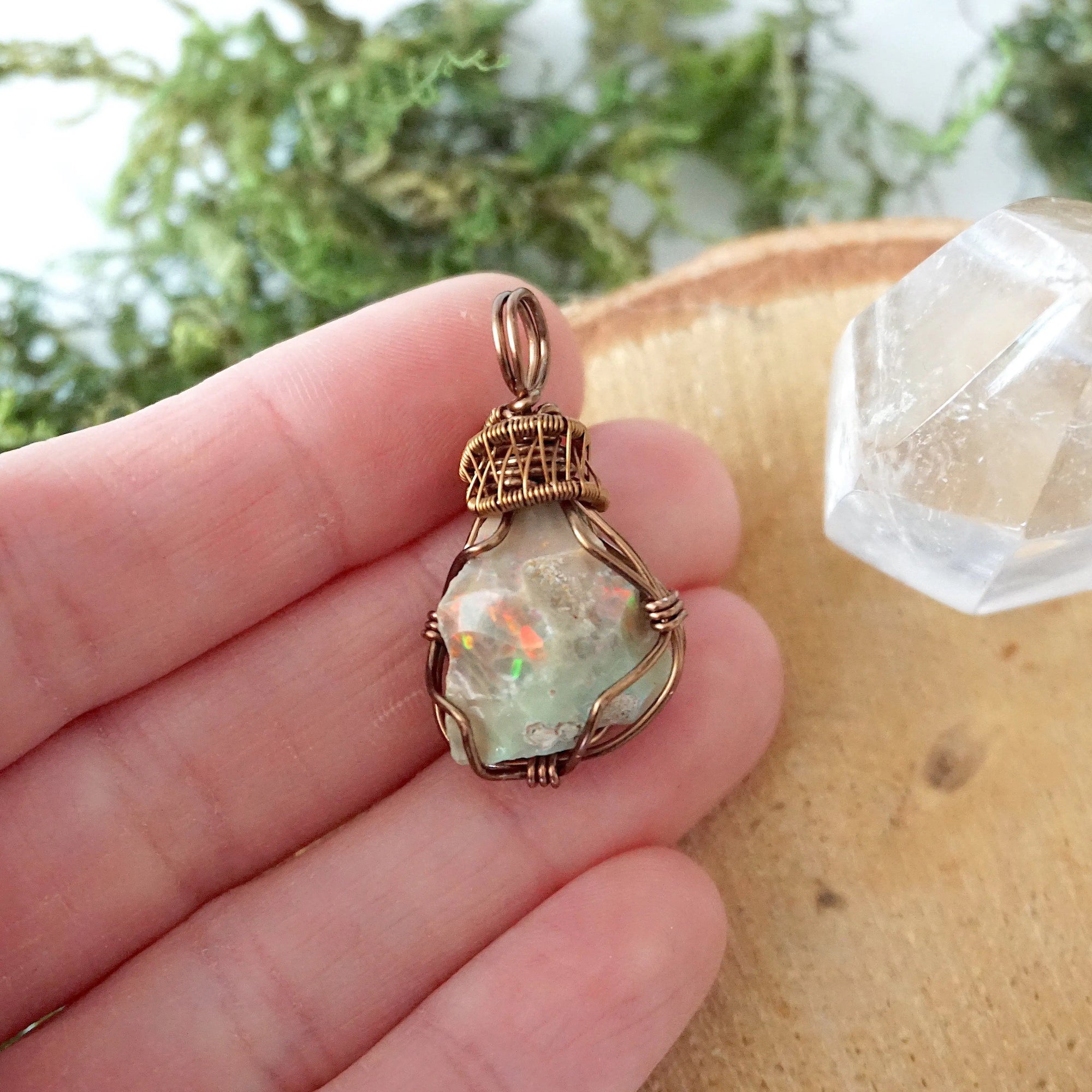 Natural opal pendant shown in hand for size reference, artisan jewelry by Designs by Nature Gems.