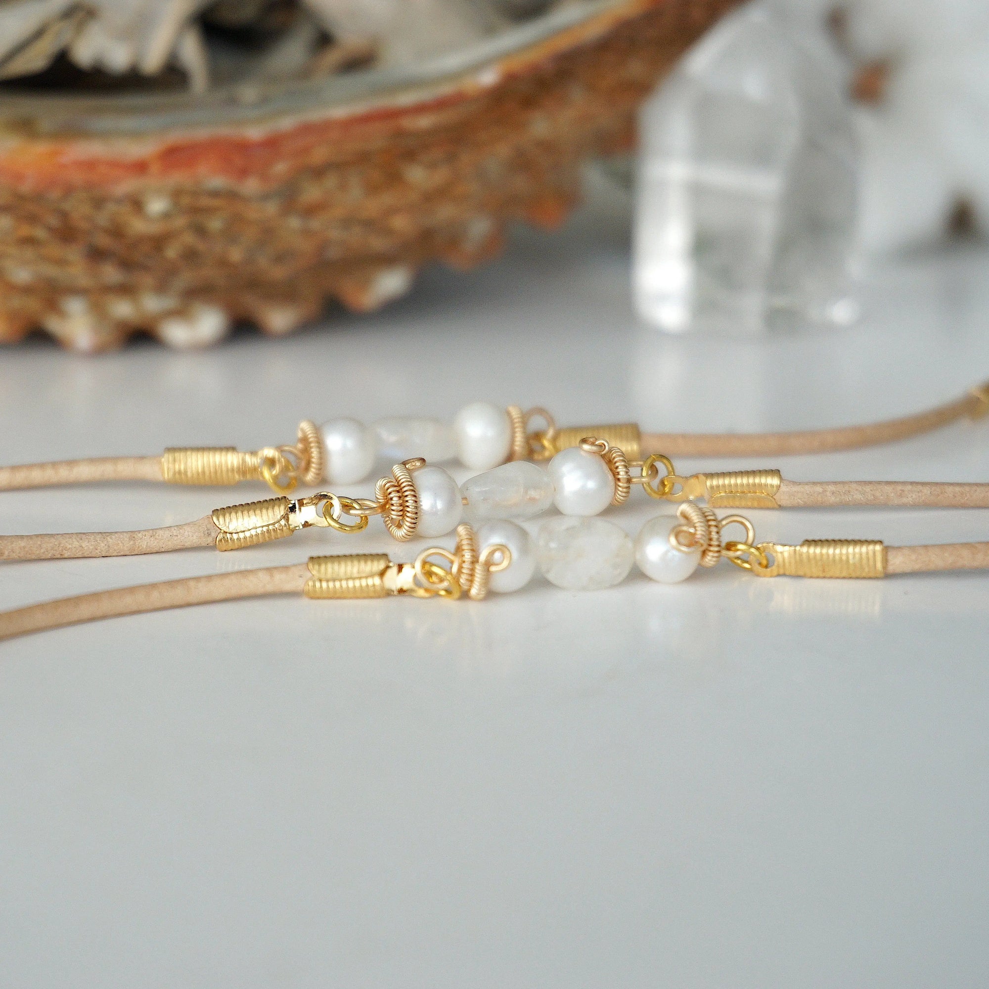 Three women’s pearl and moonstone leather bracelets showing natural variation in freshwater pearls and rainbow moonstone