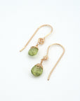Angled look at peridot drop earrings, artisan wire wrapping in 14k gold filled, August birthstone