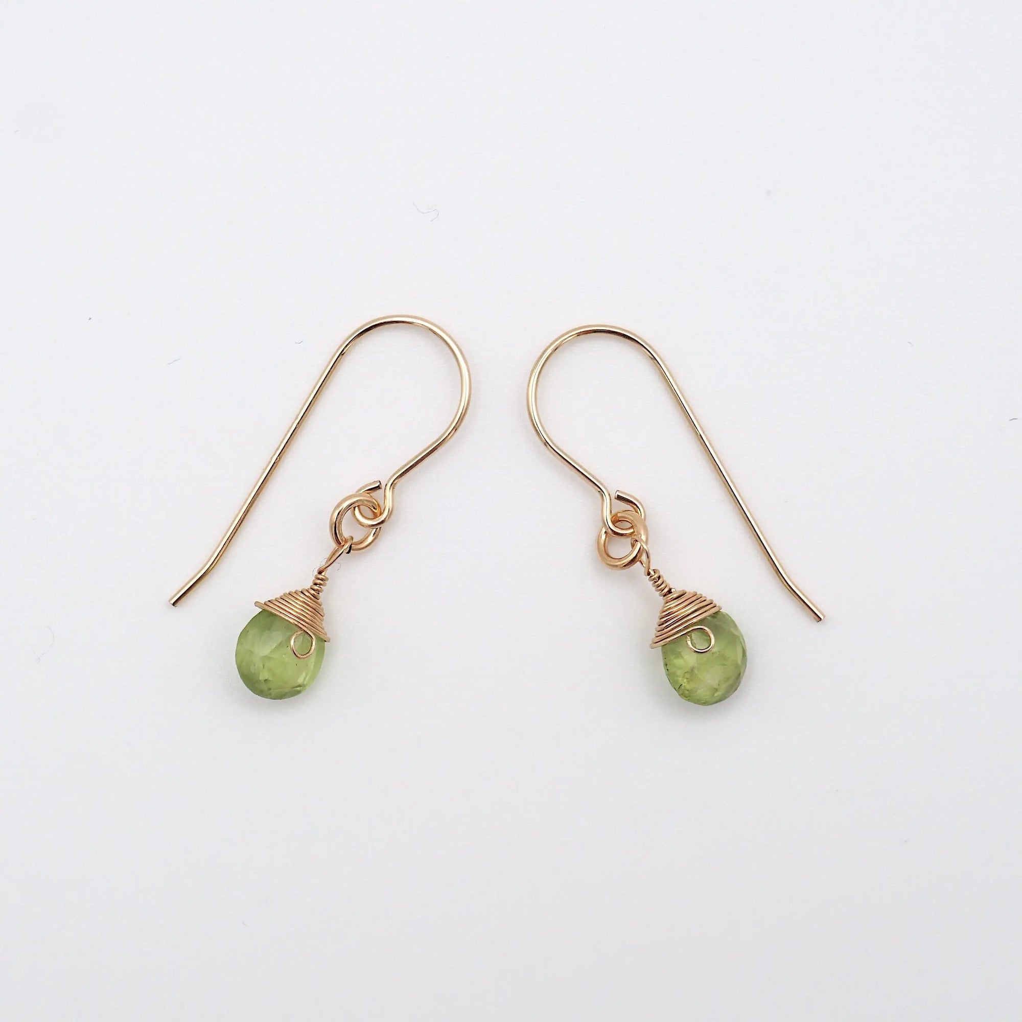 Side angle of peridot drop earrings, minimalist artisan wire wrapping, 14k gold filled