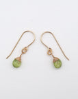 Side angle of peridot drop earrings, minimalist artisan wire wrapping, 14k gold filled