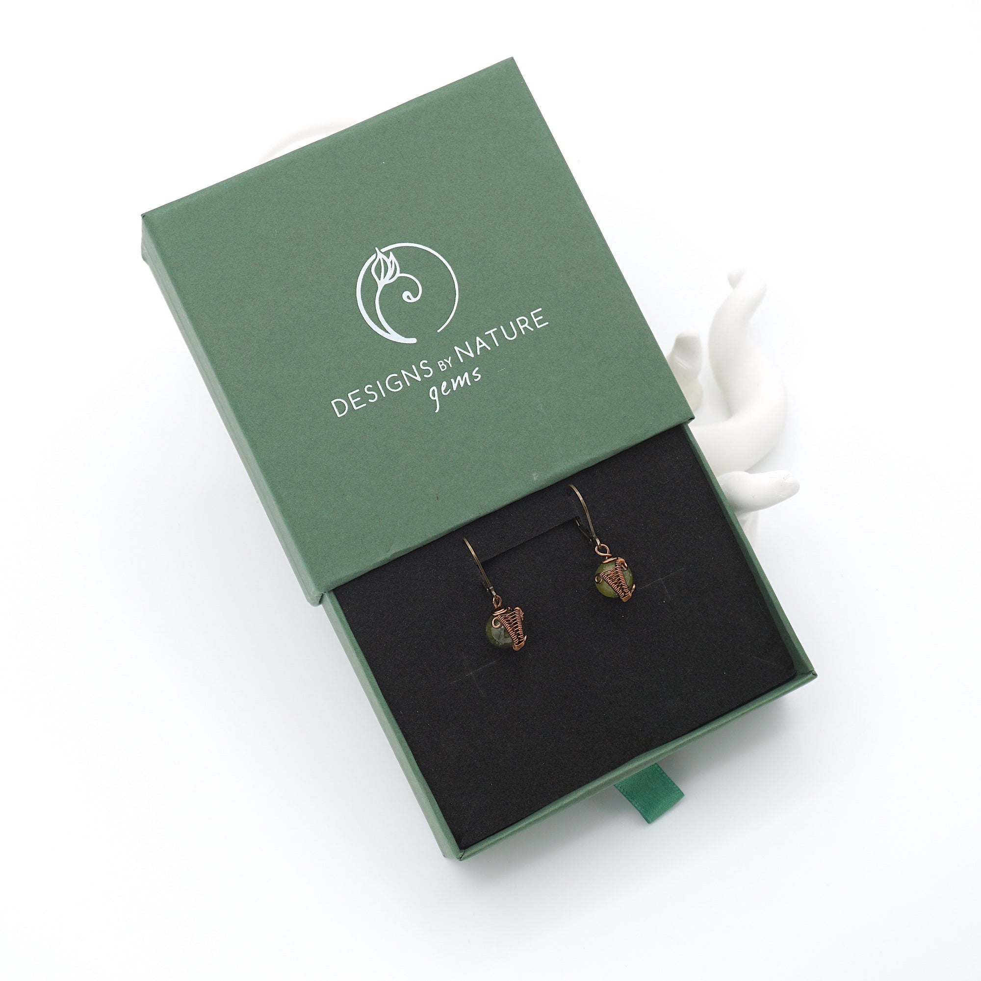 Peridot drop earrings presented in a branded gift box, ready for gifting, with antique bronze copper wire wrapping.