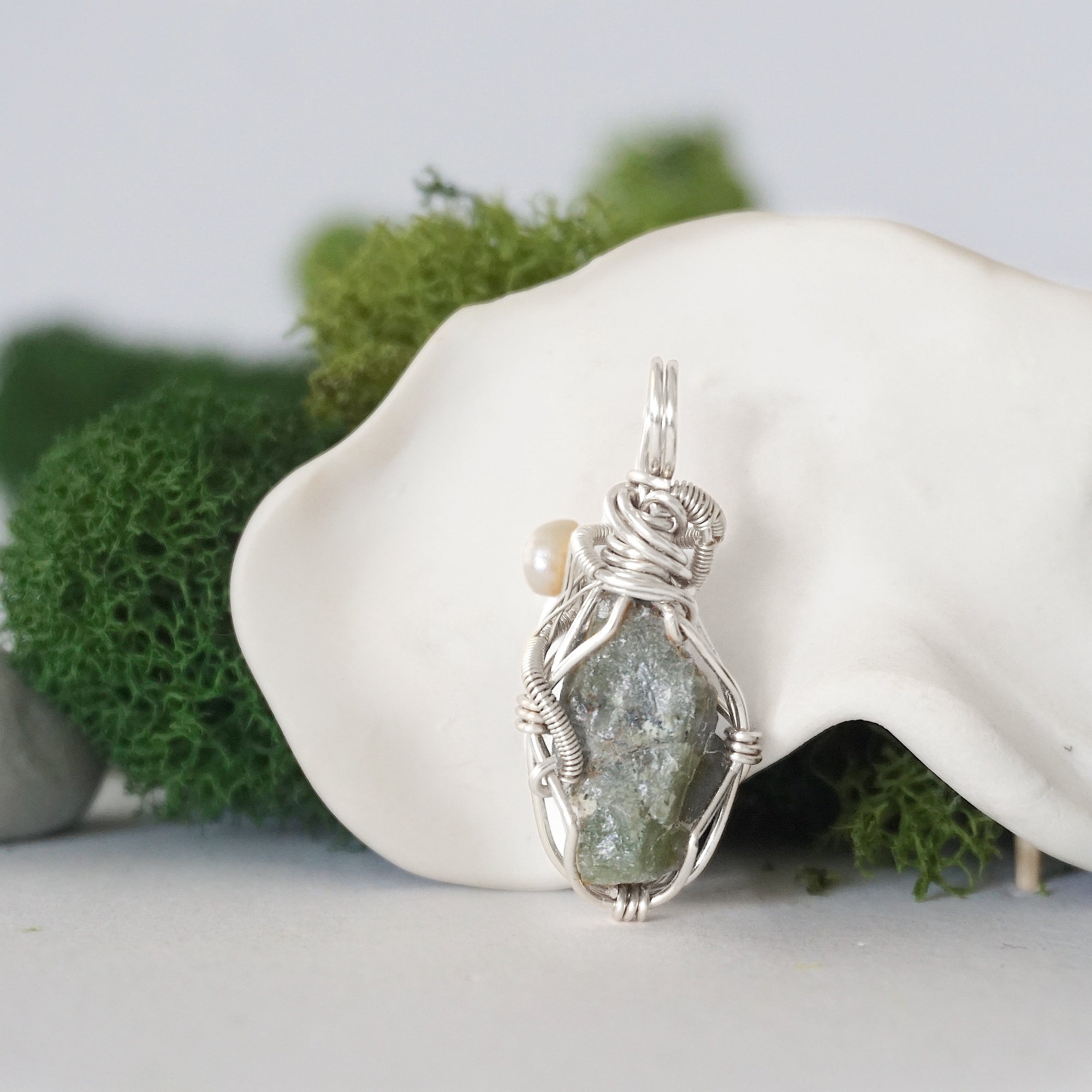 Back detail of silver wire wrapped peridot and freshwater pearl pendant necklace, handcrafted gemstone jewelry