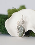 Back detail of silver wire wrapped peridot and freshwater pearl pendant necklace, handcrafted gemstone jewelry