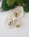 Three silver wire wrapped peridot and freshwater pearl pendants showing natural stone variation, artisan jewelry for women