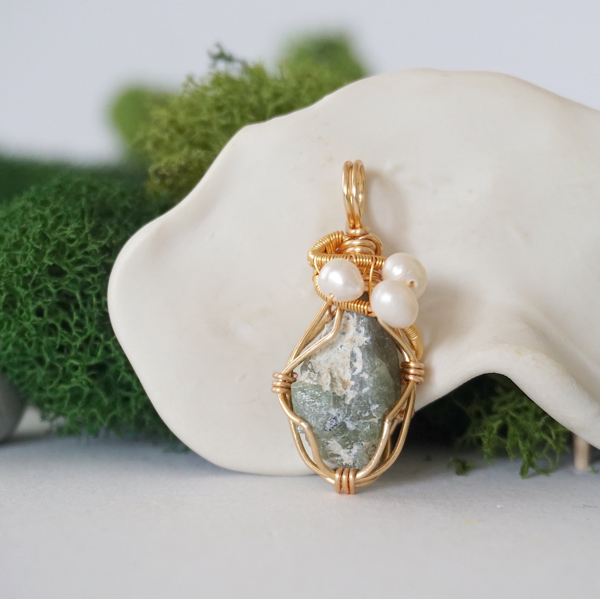 Detailed front angle of peridot and freshwater pearl pendant, gold wire wrapped, handcrafted gemstone jewelry
