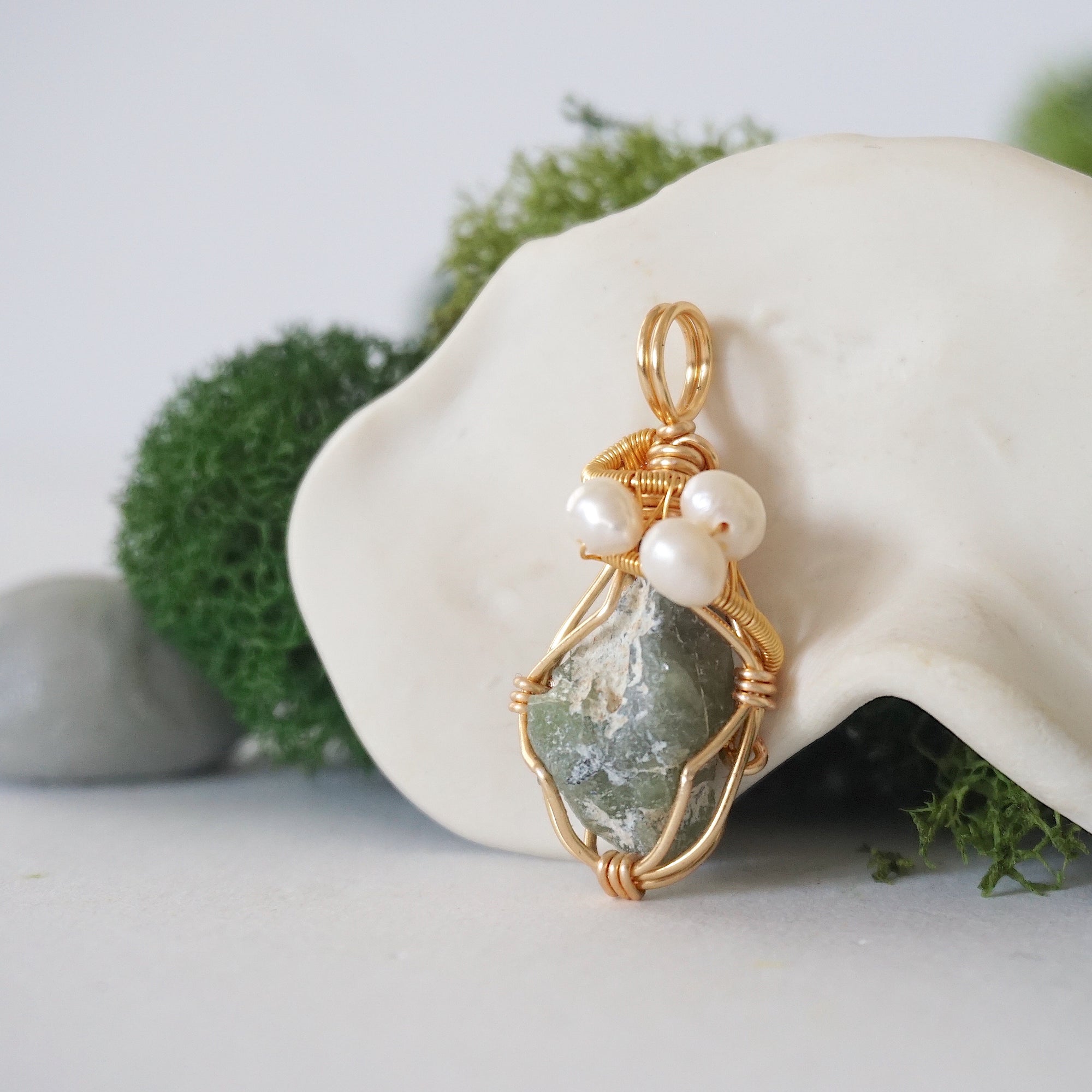 Side angle detail of peridot and freshwater pearl pendant, gold wire wrapped, ethical artisan necklace