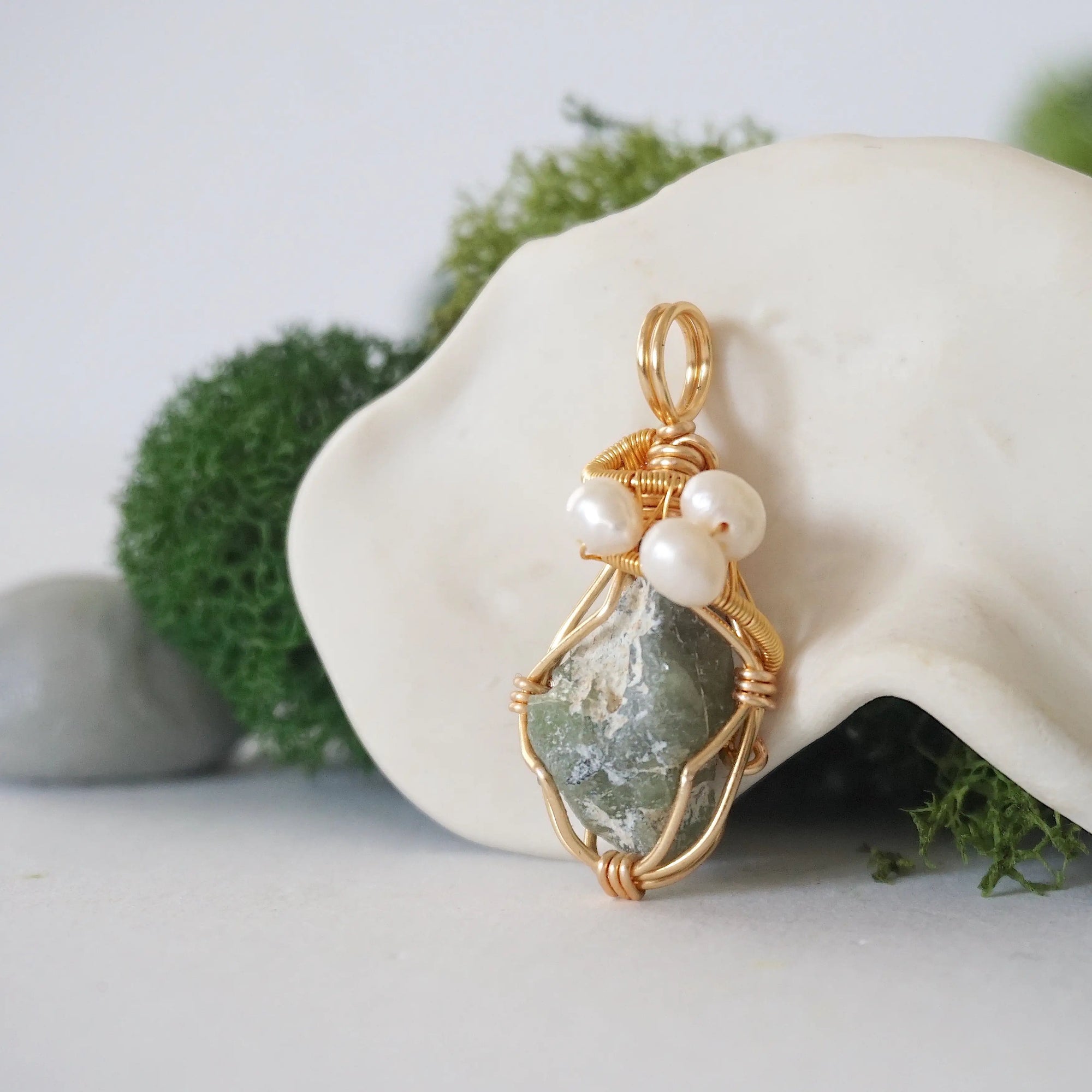 Side angle detail of peridot and freshwater pearl pendant, gold wire wrapped, ethical artisan necklace