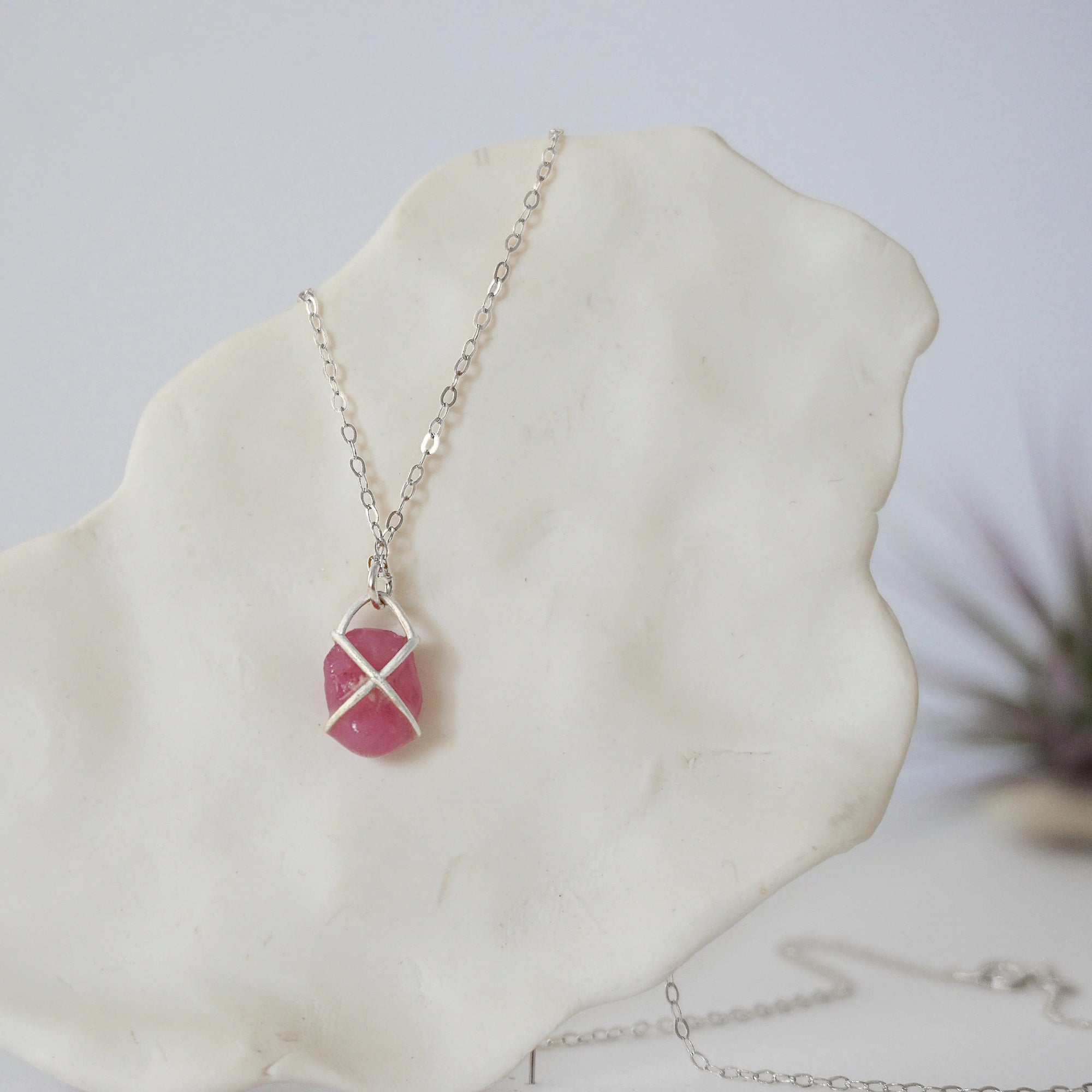 Back angle of natural pink ruby pendant in sterling silver prong setting — minimalist handmade crystal necklace, 925 sterling silver