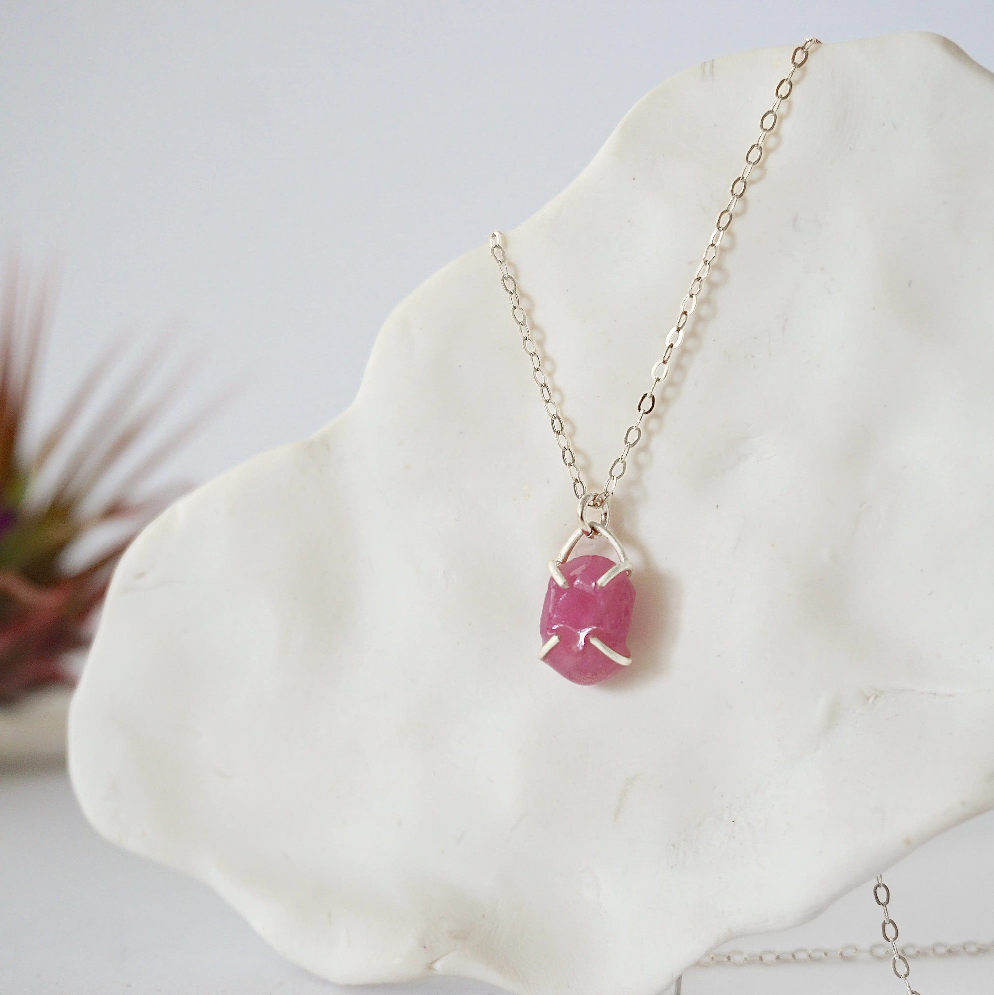 Side view of minimalist pink ruby pendant showing clean four-prong 925 sterling silver setting — natural July birthstone necklace for women