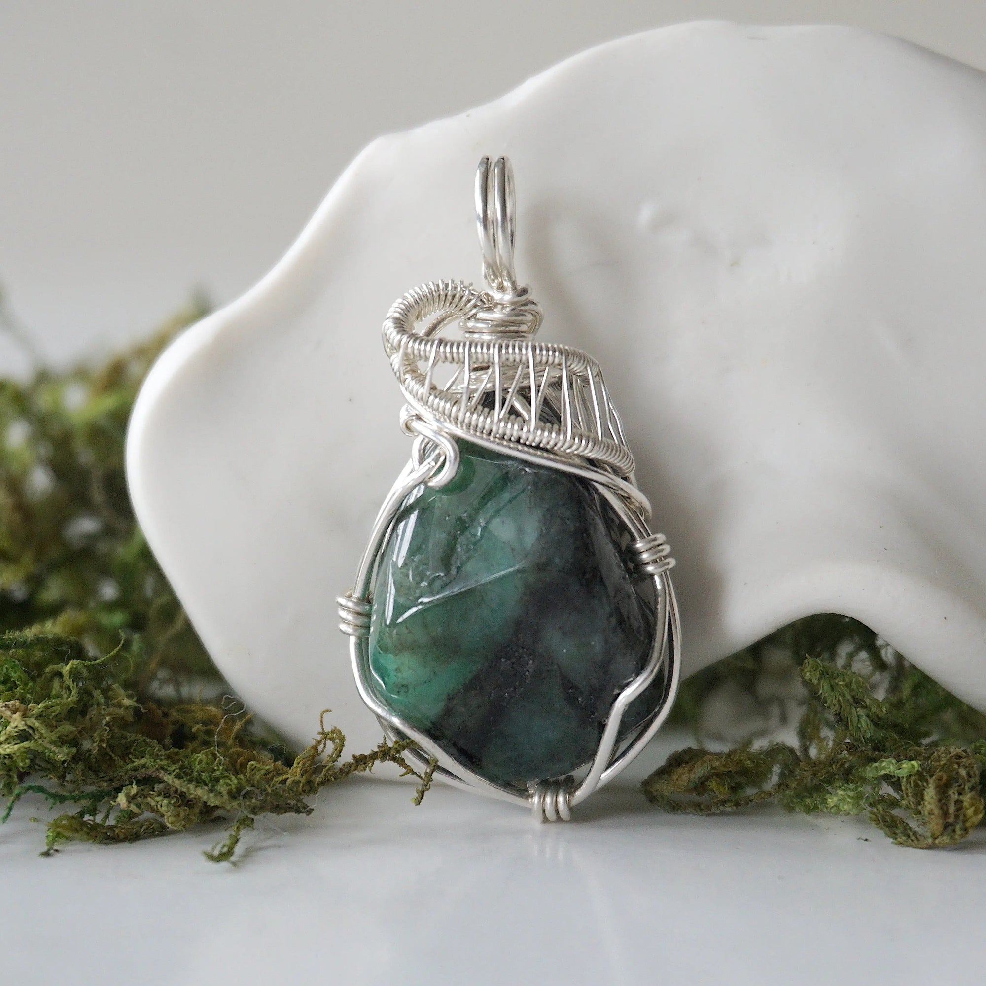 Detailed front view of polished raw emerald necklace for women with natural emerald and handcrafted 925 sterling silver wire wrapping